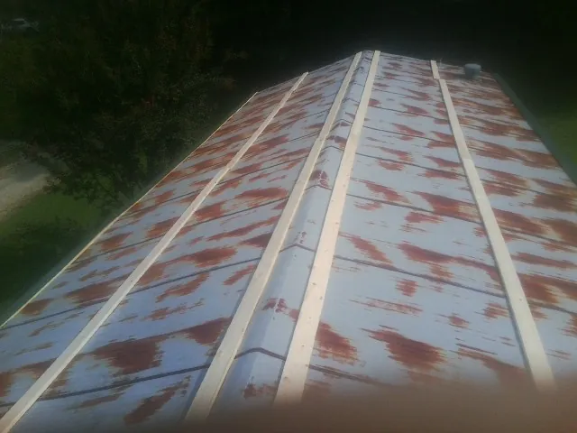 Rusted metal roof panels with new wood purlins before replacement — Storm Damage Roof Repair in Fort Plain by Roofing Brothers